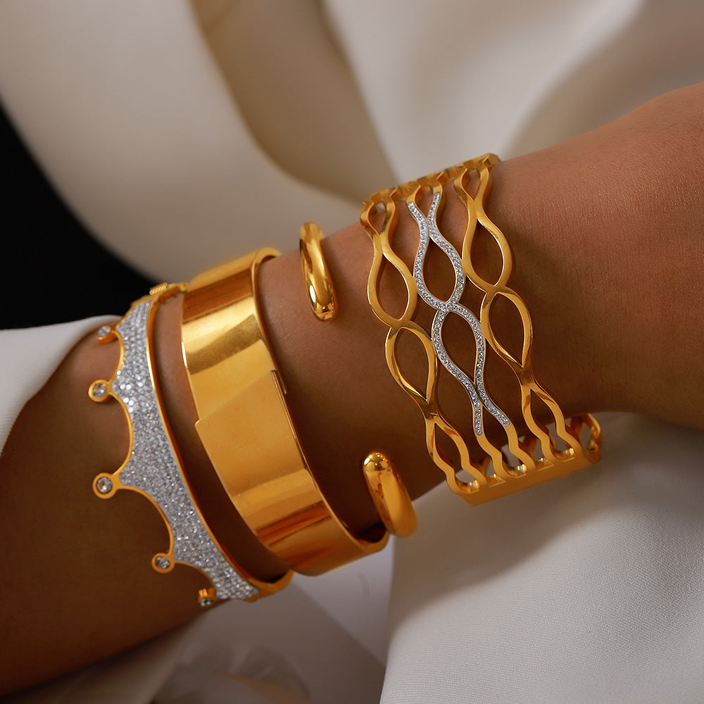 Women wearing 18k gold plated rhinestone bangle set, stacked hollow wave crown cuff bracelet