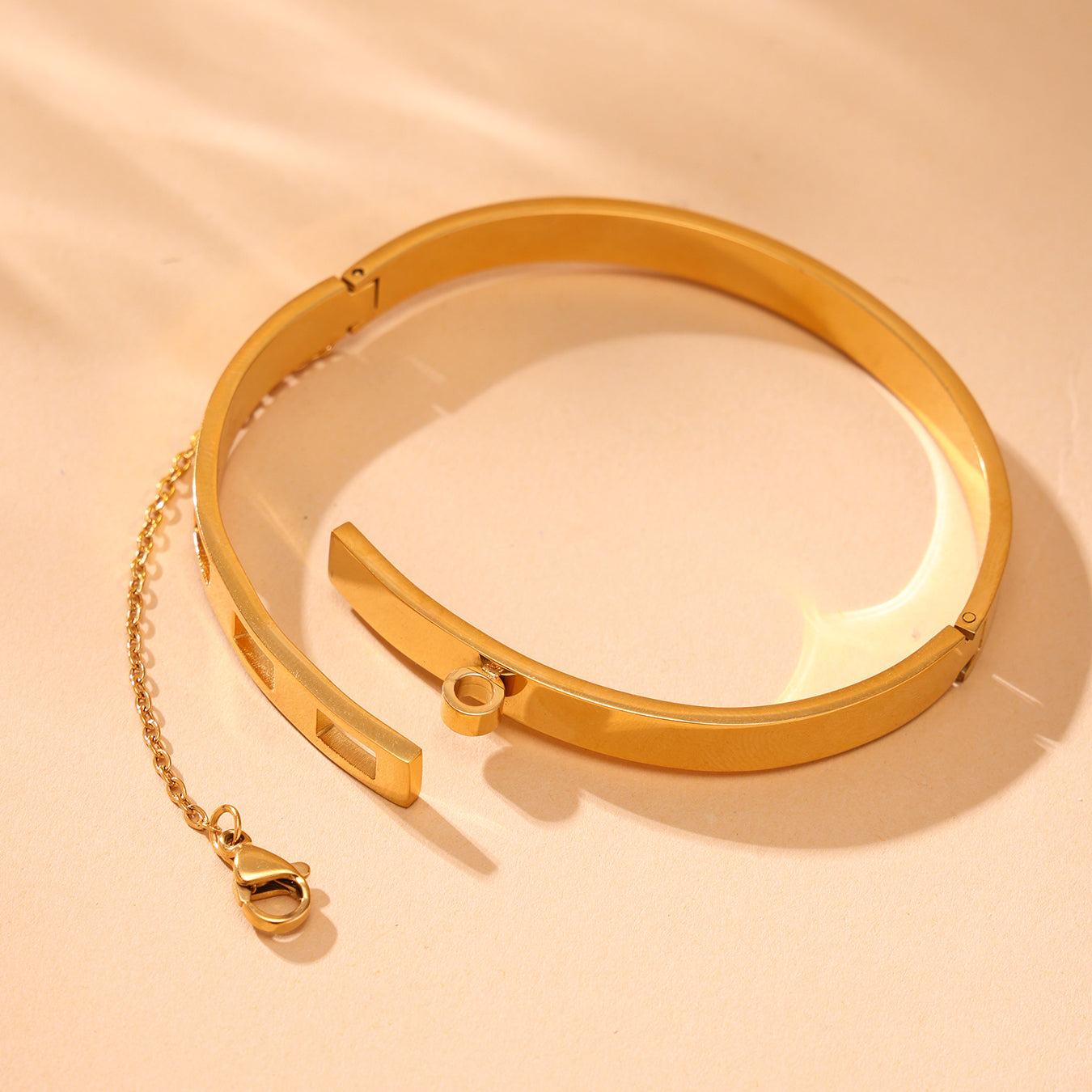 18K gold plated stainless steel chain clasp bracelet displayed on beige background, luxury jewelry