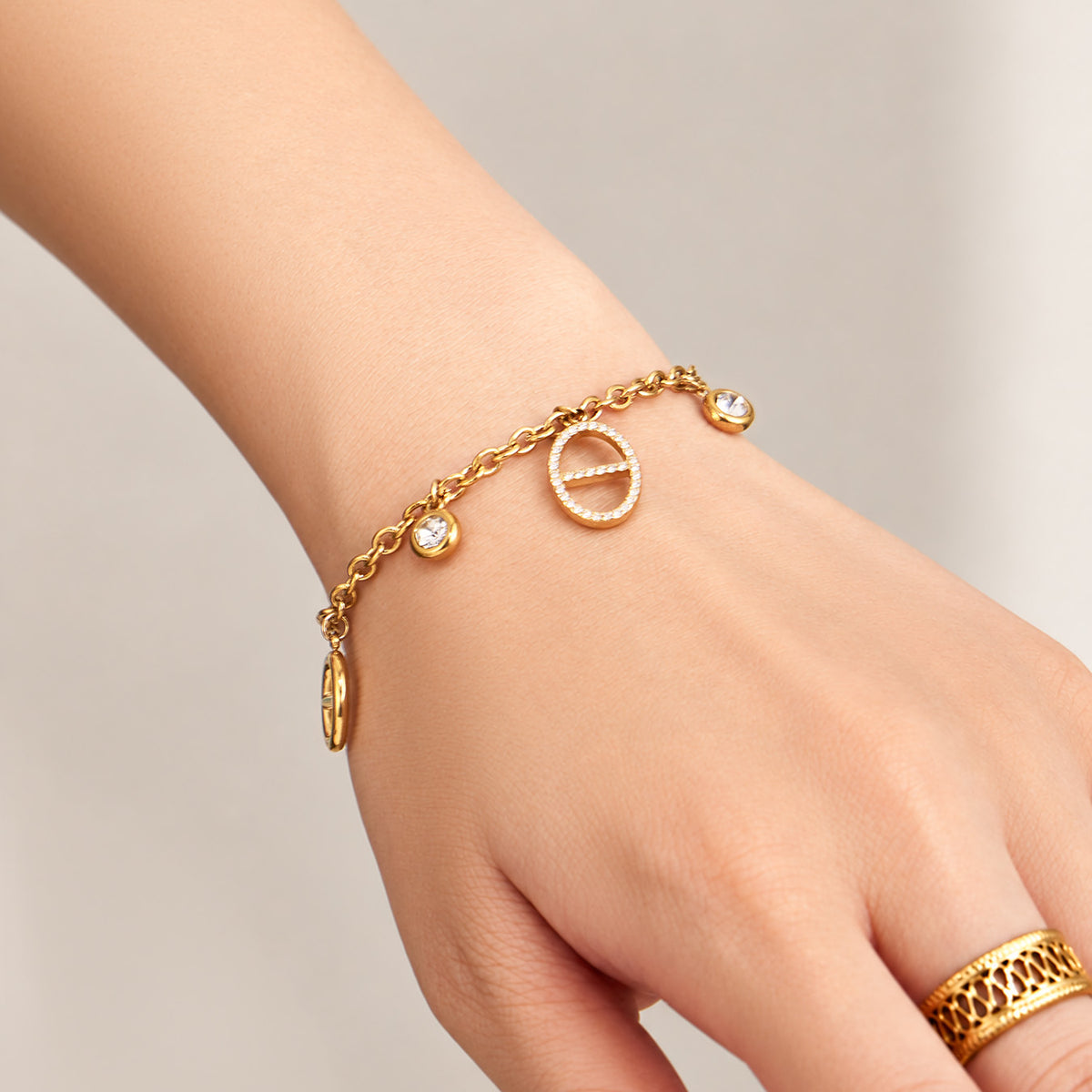 18K gold PVD stainless steel charm bracelet wrist detail