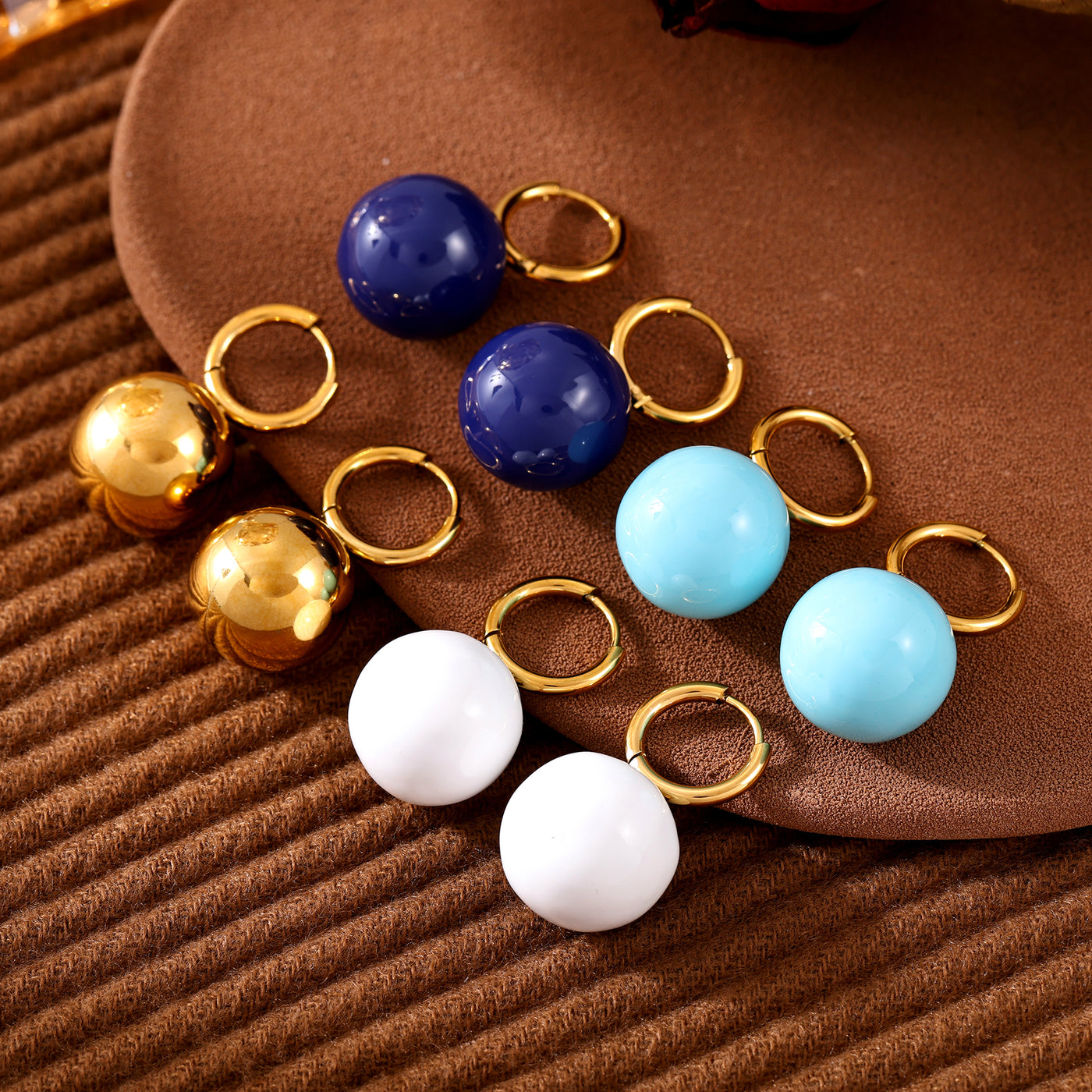 Gold-tone hoop earrings with gold, navy, light blue and white ball drops