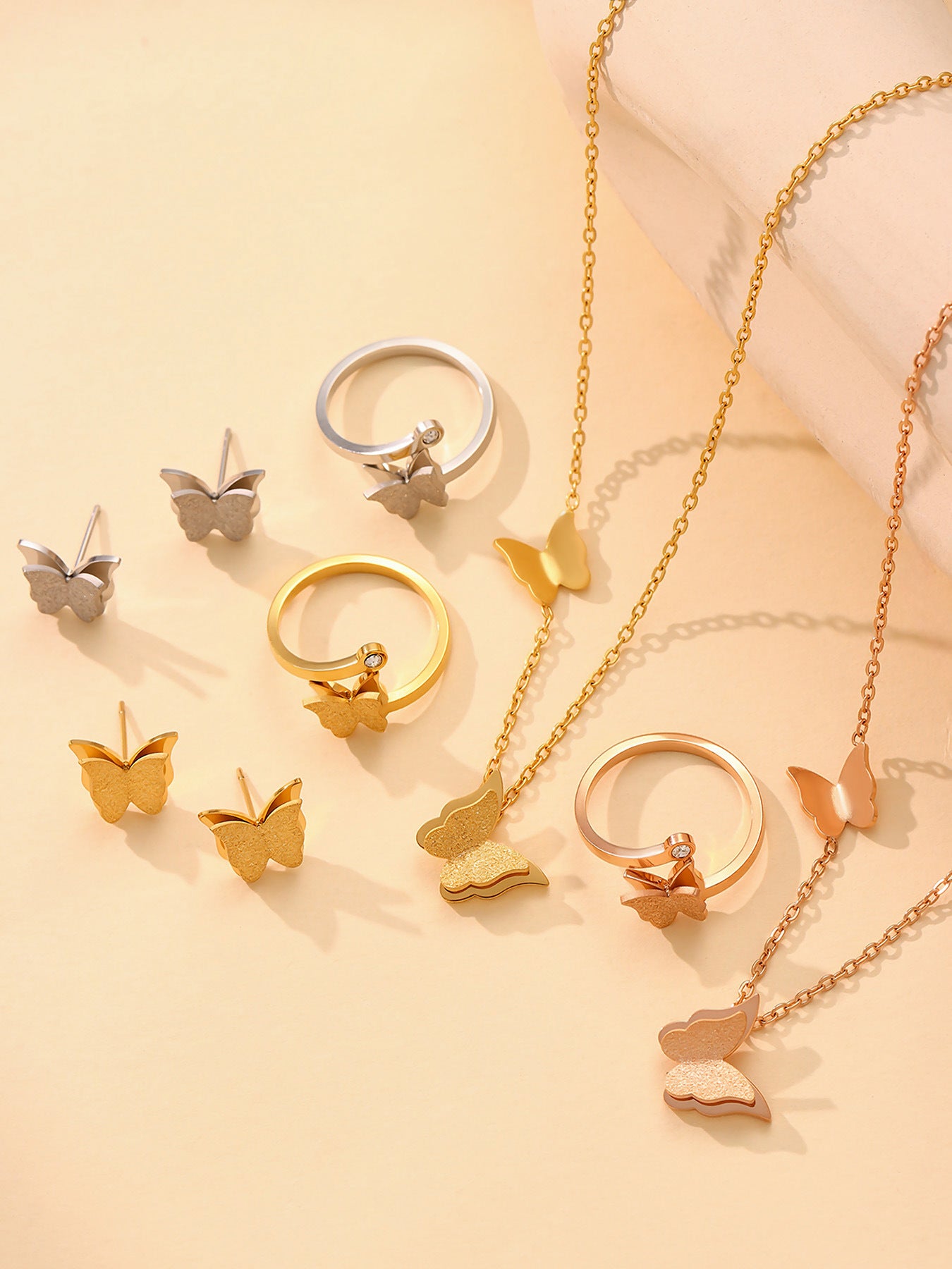 Product dimension diagram for the gold butterfly necklace and earrings showing the pendant size and total weight for wholesale jewelry buyers.