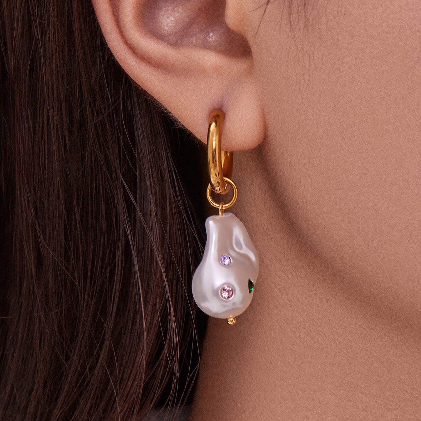 Close up of model wearing elegant waterproof 18K gold plated baroque pearl dangle earrings for sensitive skin.