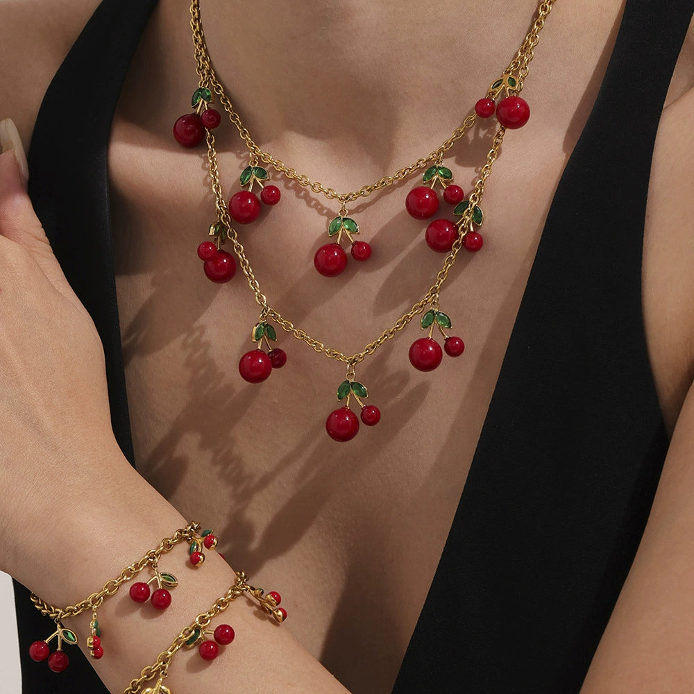 A model wearing the hypoallergenic 18K gold plated cherry necklace, showcasing its playful and elegant design on sensitive skin.