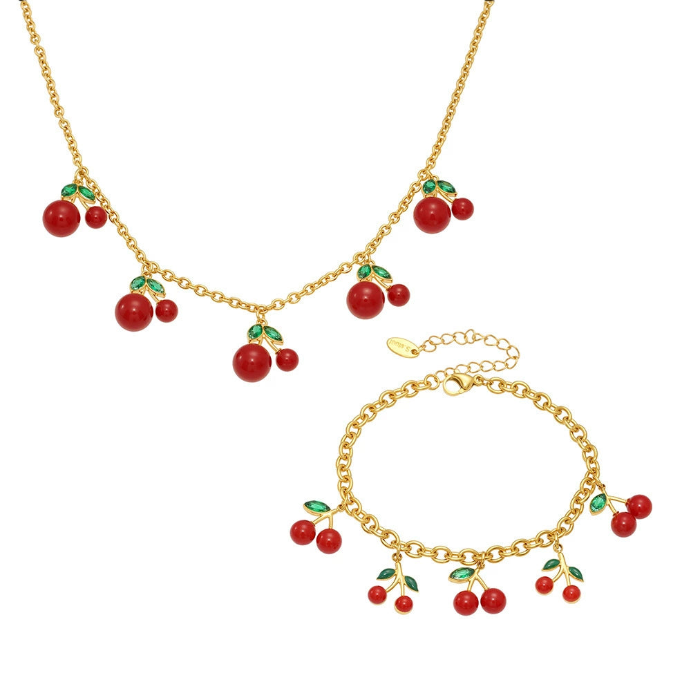 A complete 316L stainless steel cherry jewelry set including a gold necklace and matching bracelet with vibrant red cherry charms.