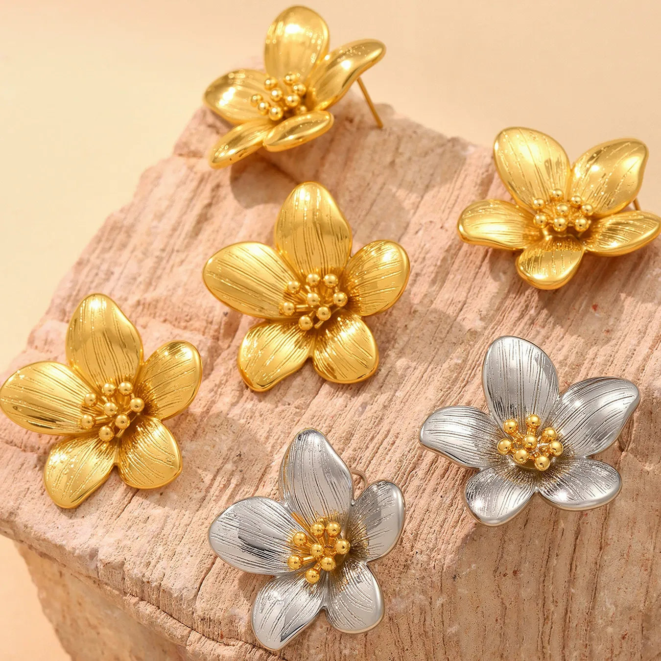 Collection of tarnish-free 316L stainless steel hypoallergenic earrings featuring gold and two-tone sunflower studs.