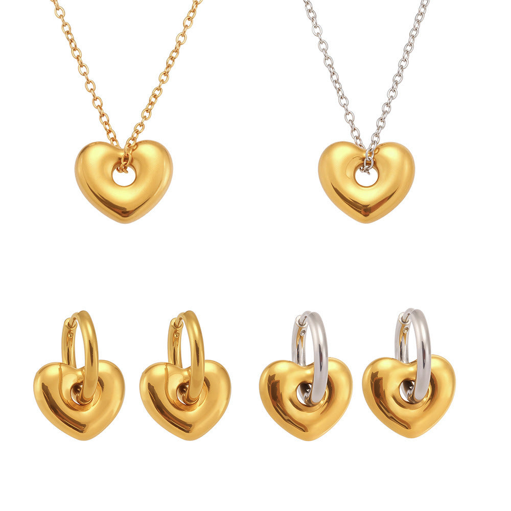 A collection of 316L stainless steel puffed heart necklaces and hoop earrings in gold and two-tone finishes.