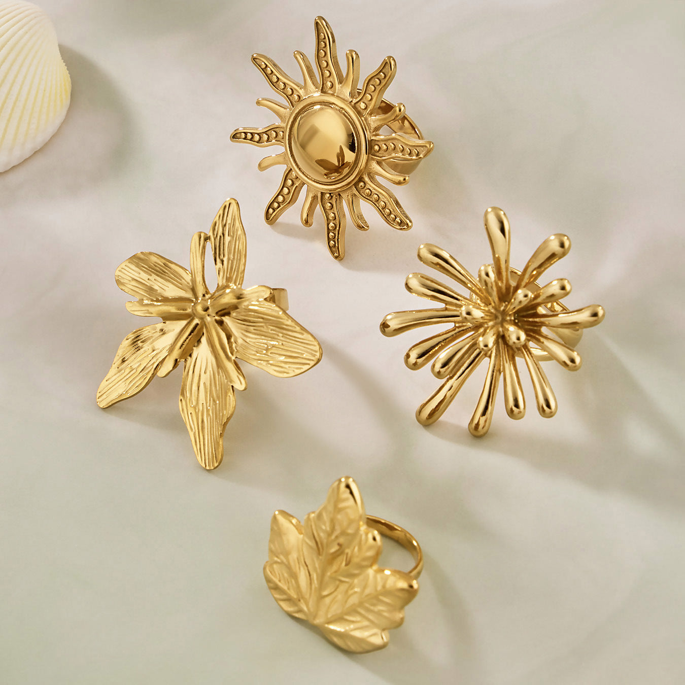 Wholesale Stainless Steel Jewelry Sun and Flower Rings Displayed on Textured Aesthetic Background