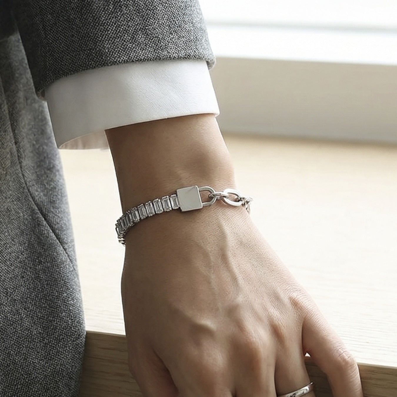 Male model wearing 316L stainless steel 18K gold PVD lock link bracelet, unisex waterproof jewelry for wholesale