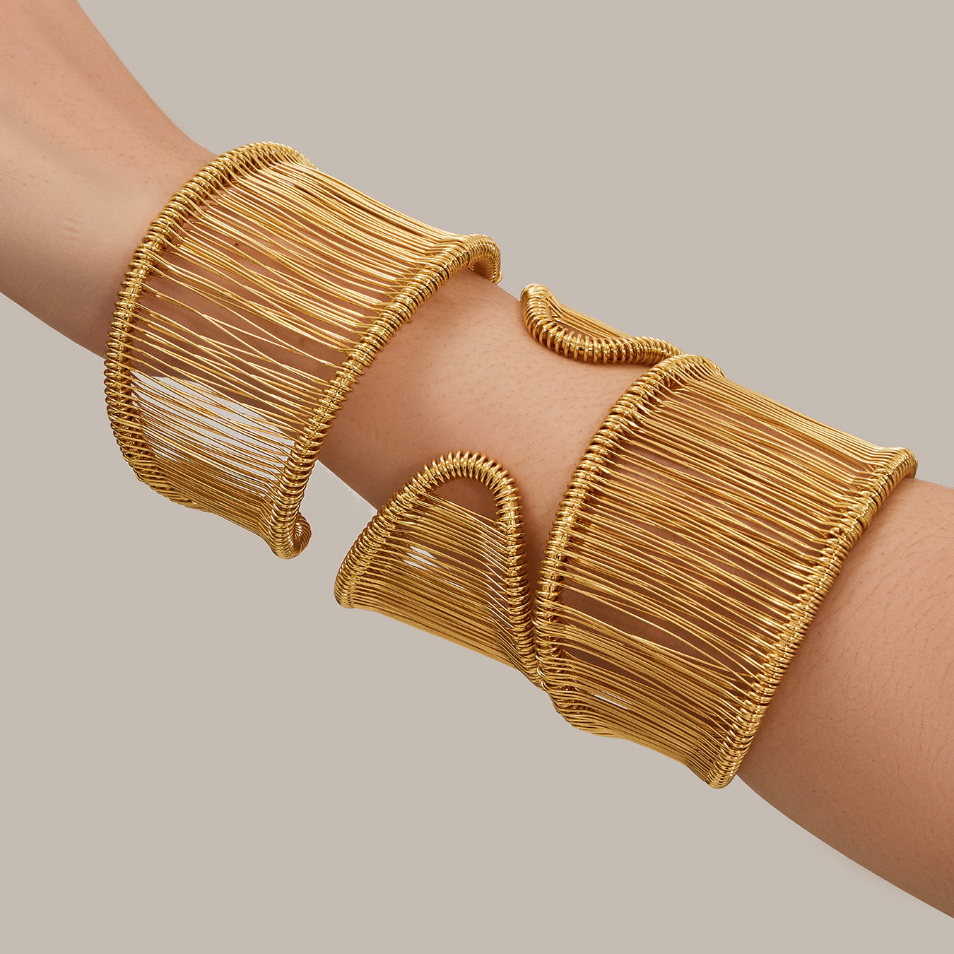 Set of wide wire cuff bracelets in 316L stainless steel with 18K PVD gold plating, sculptural open bangles for statement styling