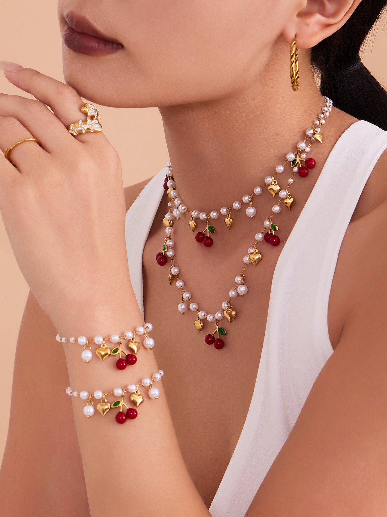 A chic heart and cherry pendant necklace made of tarnish-free stainless steel for a sophisticated summer look.