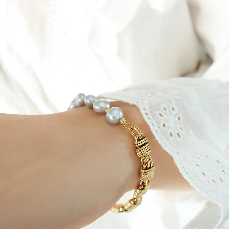 Close-up of gold grey pearl bracelet worn on wrist for boutique gift jewelry and feminine bracelet displays