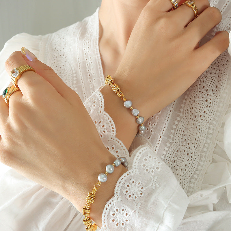 Model wearing grey freshwater pearl bracelet with gold plated copper accents for elegant everyday jewelry styling