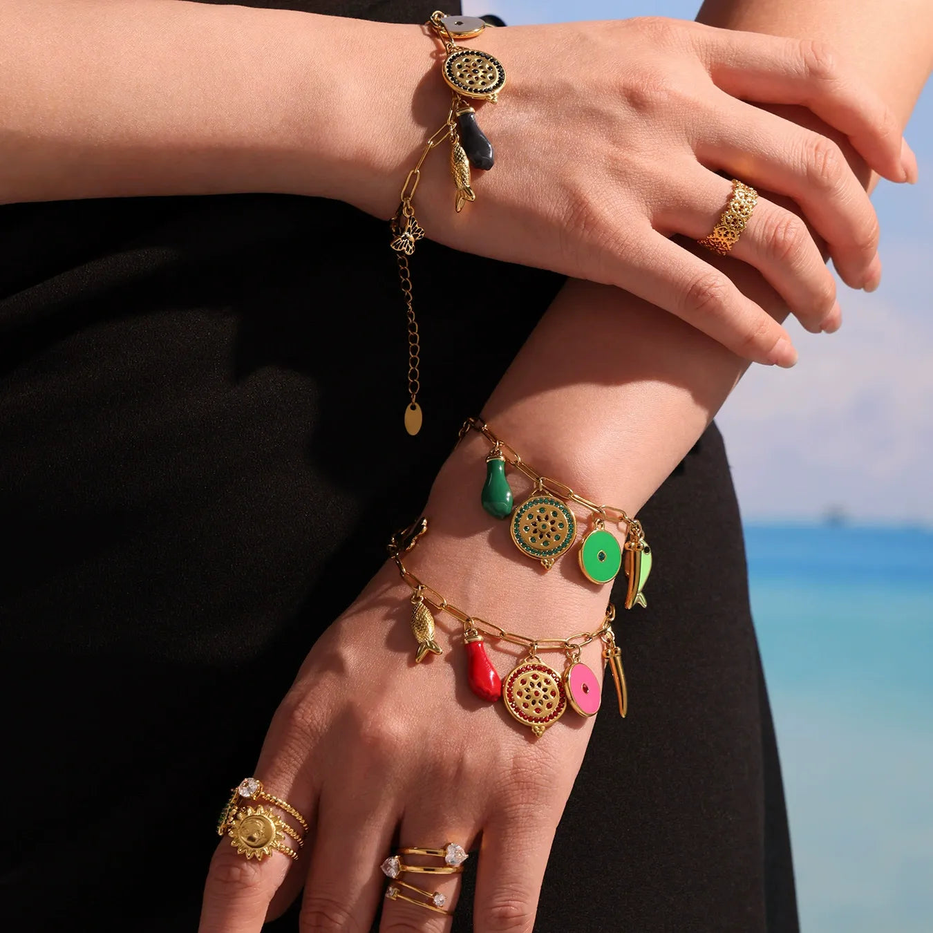 Gold enamel charm bracelet worn on wrist for summer boutique jewelry