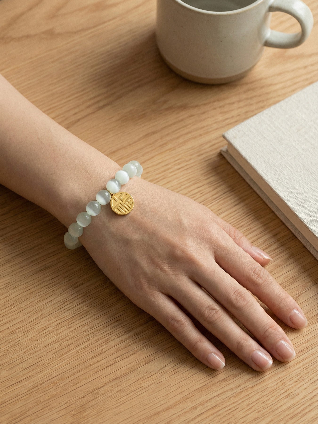 Model wearing 316L Stainless Steel cat's eye stone bead bracelet, casual everyday waterproof jewelry
