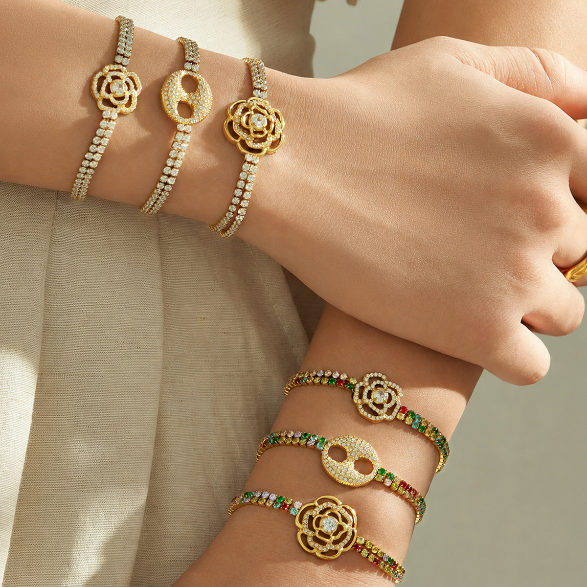 White and multicolor flower zircon bracelets styled together on both wrists