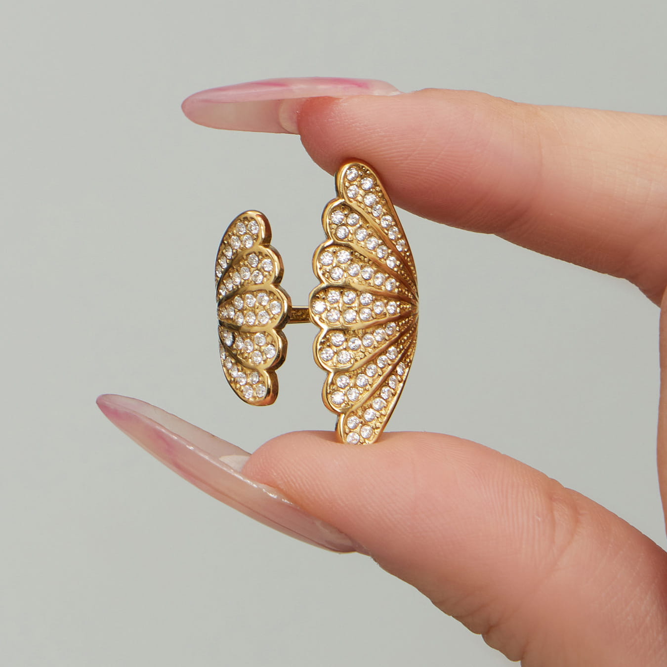 Close-up of 316L stainless steel shell zircon open ring with pavé setting