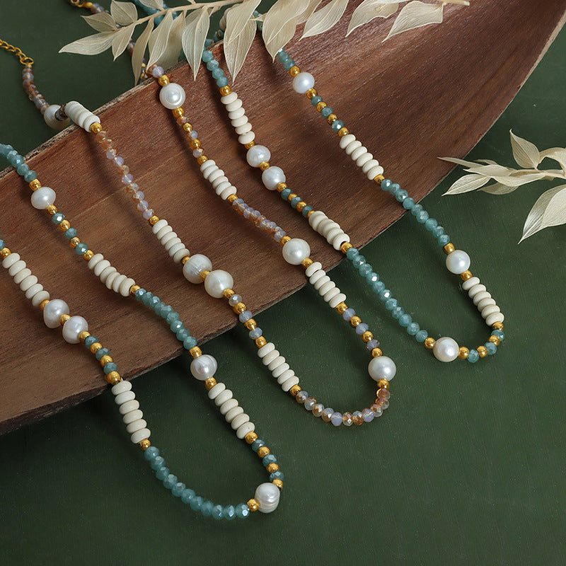 Lifestyle scene showing 316L stainless steel pearl and glass stone necklace for boutique brands