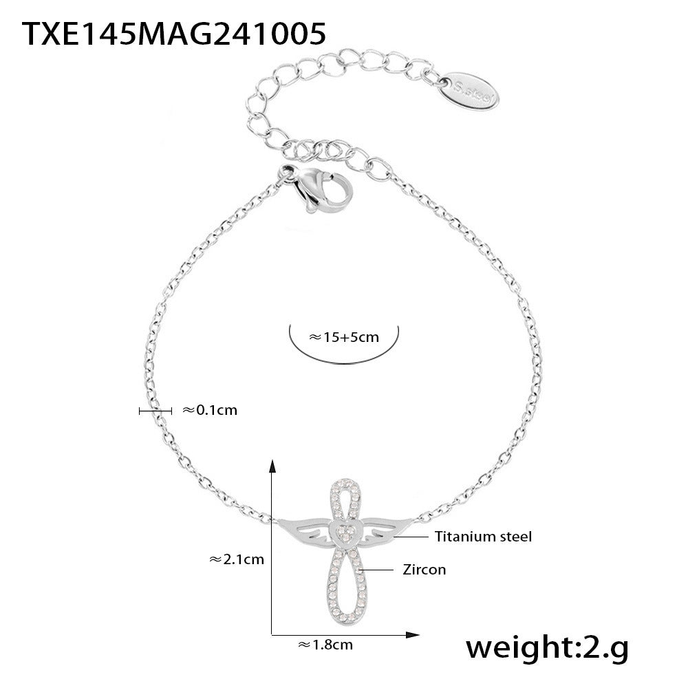 Silver tone angel wing CZ charm bracelet in stainless steel, 15+5cm extender, minimalist luxury style.
