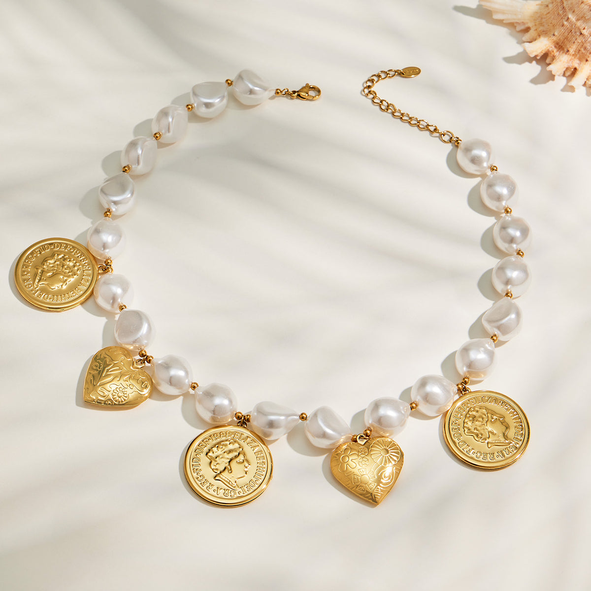Beaded heart charm necklace with gold coin and heart pendants flat lay