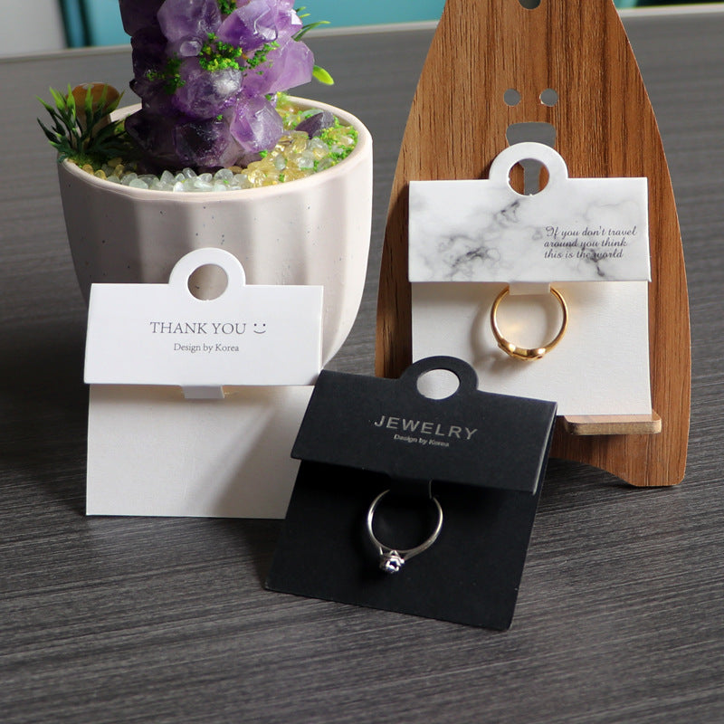 Black and white ring display cards arranged together for jewelry retail presentation