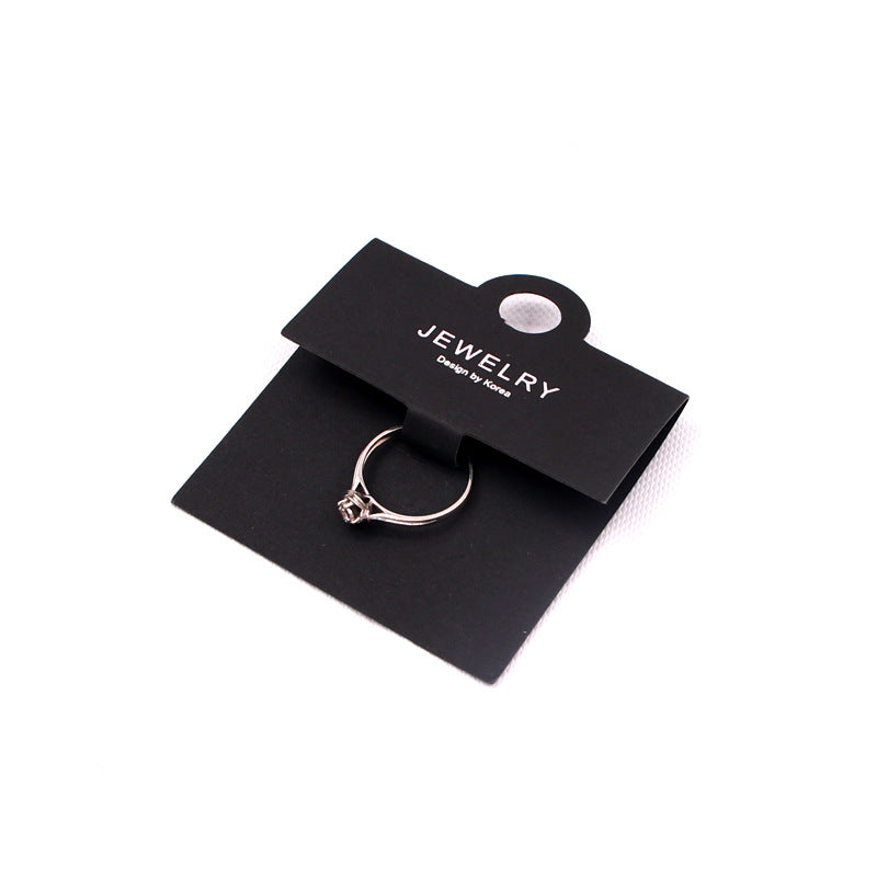 Black ring display card with a ring mounted for jewelry packaging and retail presentation