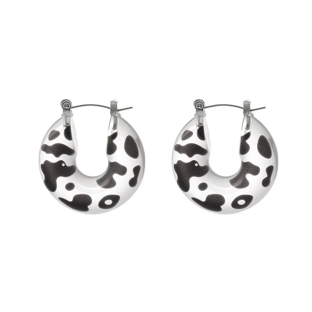 Black and white leopard print resin hoop earrings with 316L stainless steel posts on a white background
