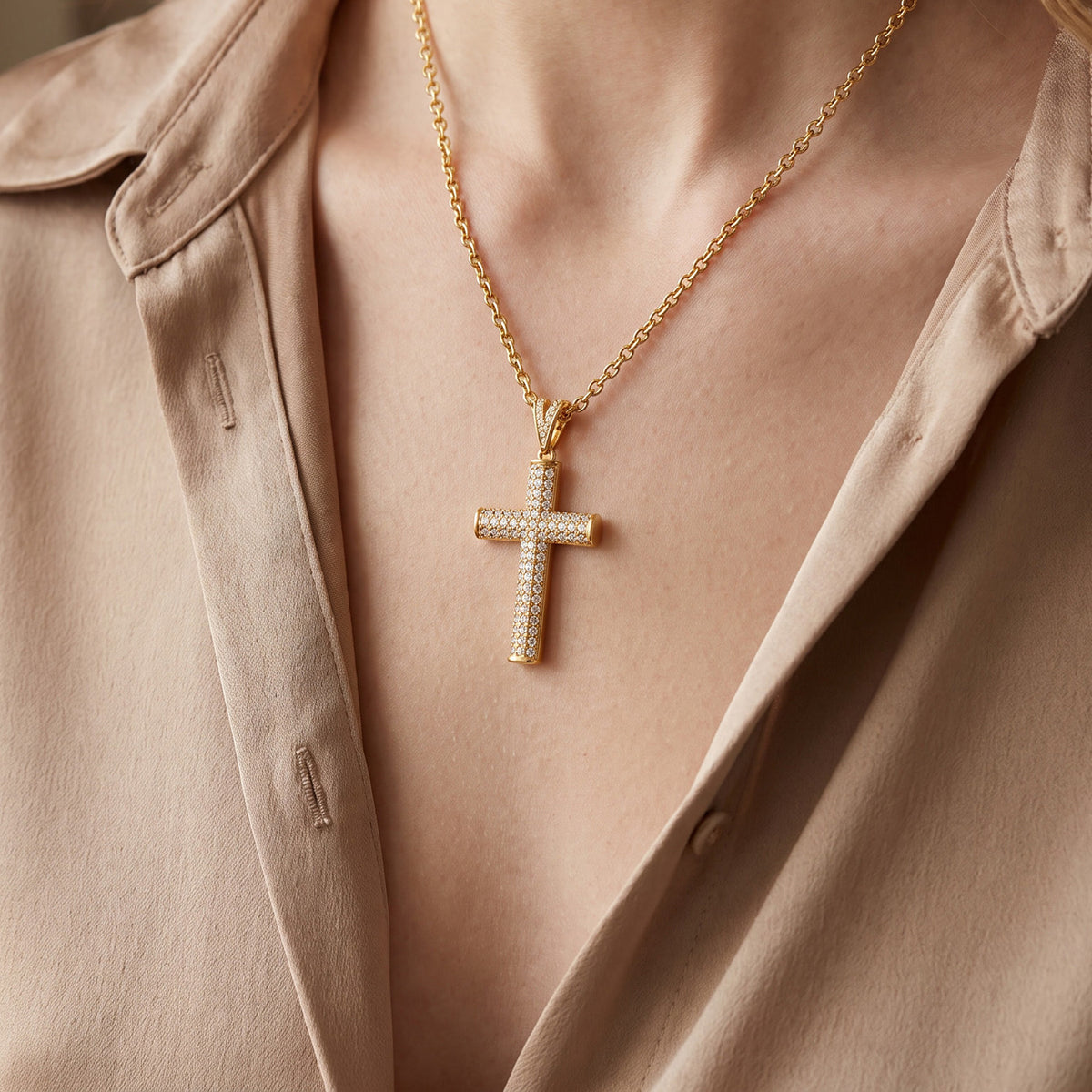 Classic gold cross pendant necklace worn on model