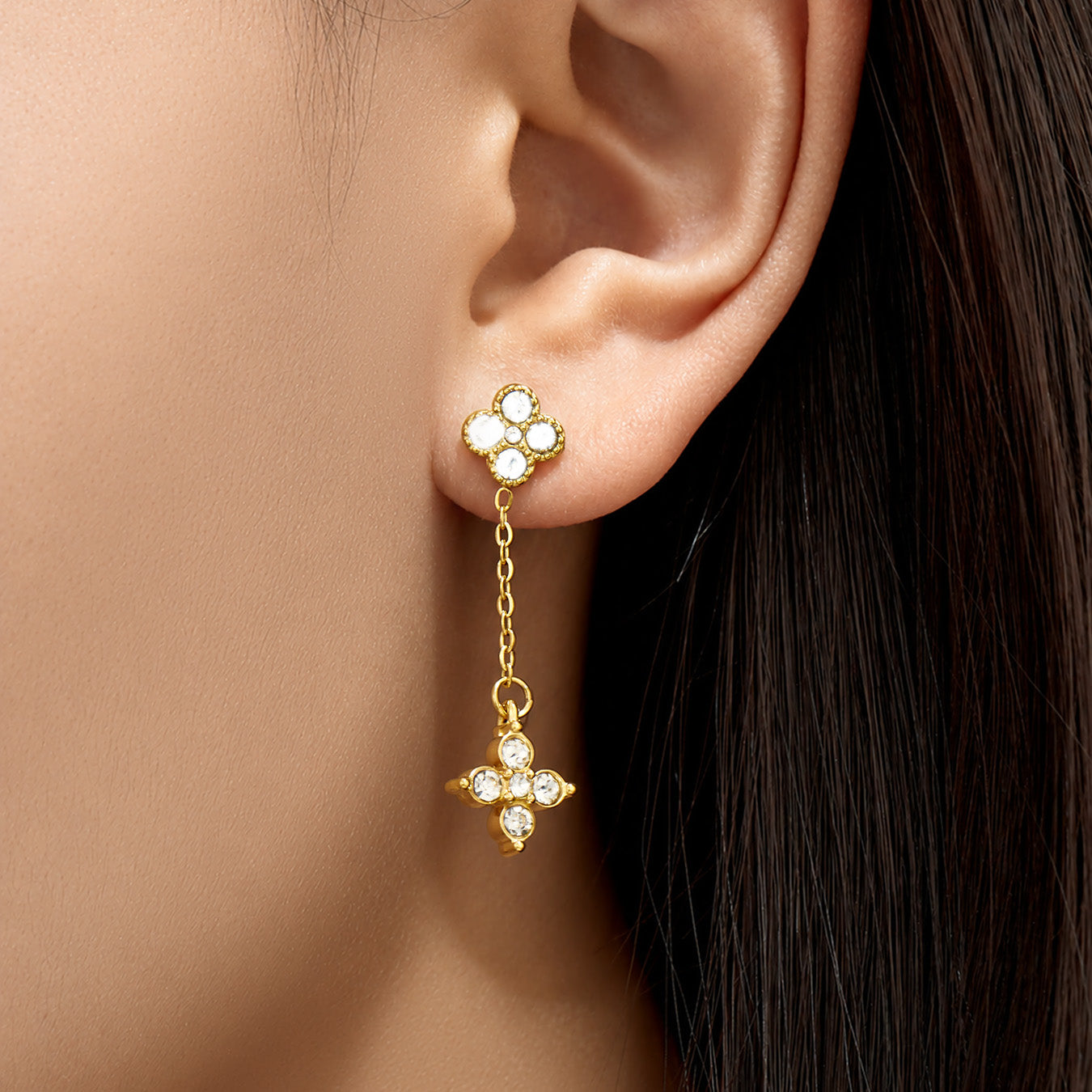 Model wearing clear cubic zirconia four-leaf clover drop earrings