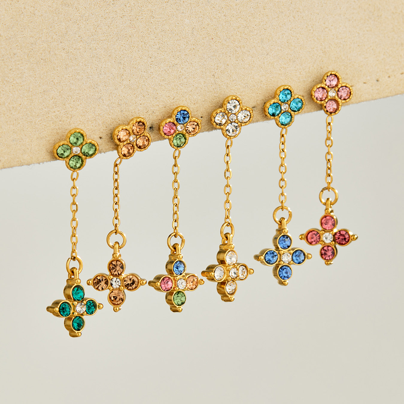 Colorful four-leaf clover drop earrings displayed in multiple cubic zirconia colors