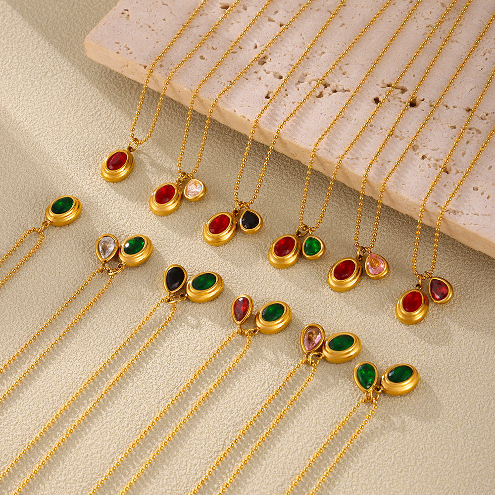 Colorful zircon pendant necklaces arranged in rows on a striped neutral surface