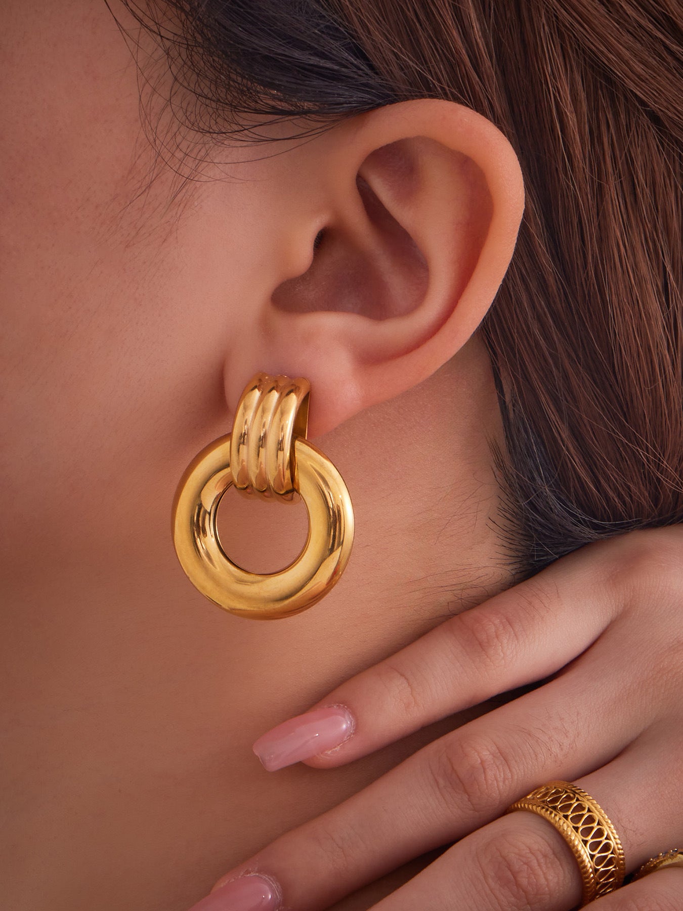 F476 gold compact round stainless steel door knocker earrings worn by model