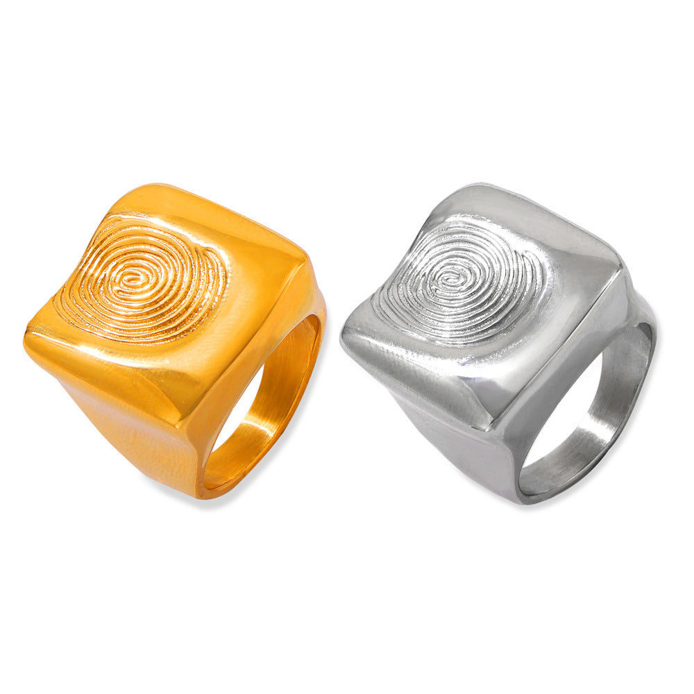 Gold-tone and steel-tone fingerprint statement rings in stainless steel with chunky square textured faces