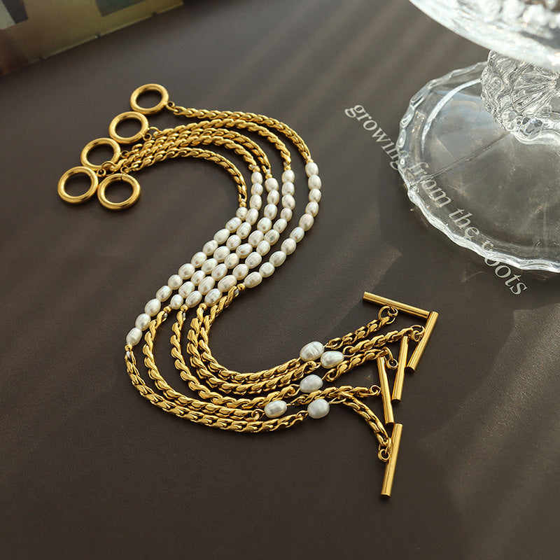 Freshwater pearl chain bracelet with stainless steel links displayed in gold tone styling
