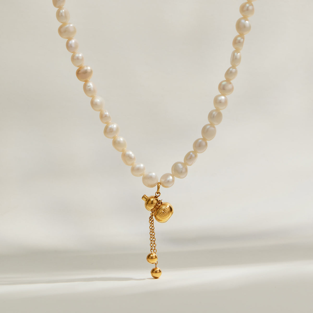 Freshwater pearl pendant necklace with gold charm front view