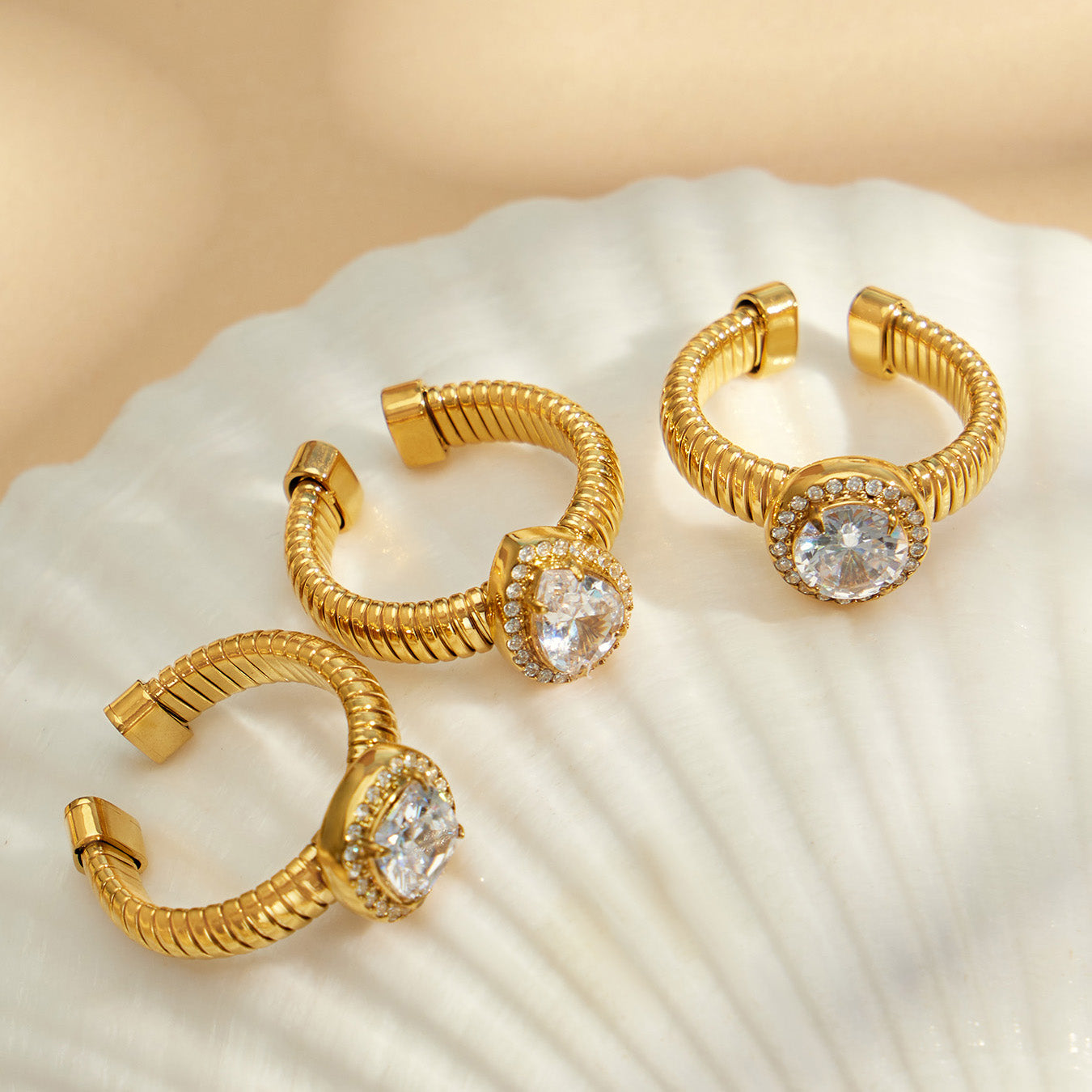 Gold 5A zircon open rings displayed with shell, featuring waterdrop, round and square geometric ring styles