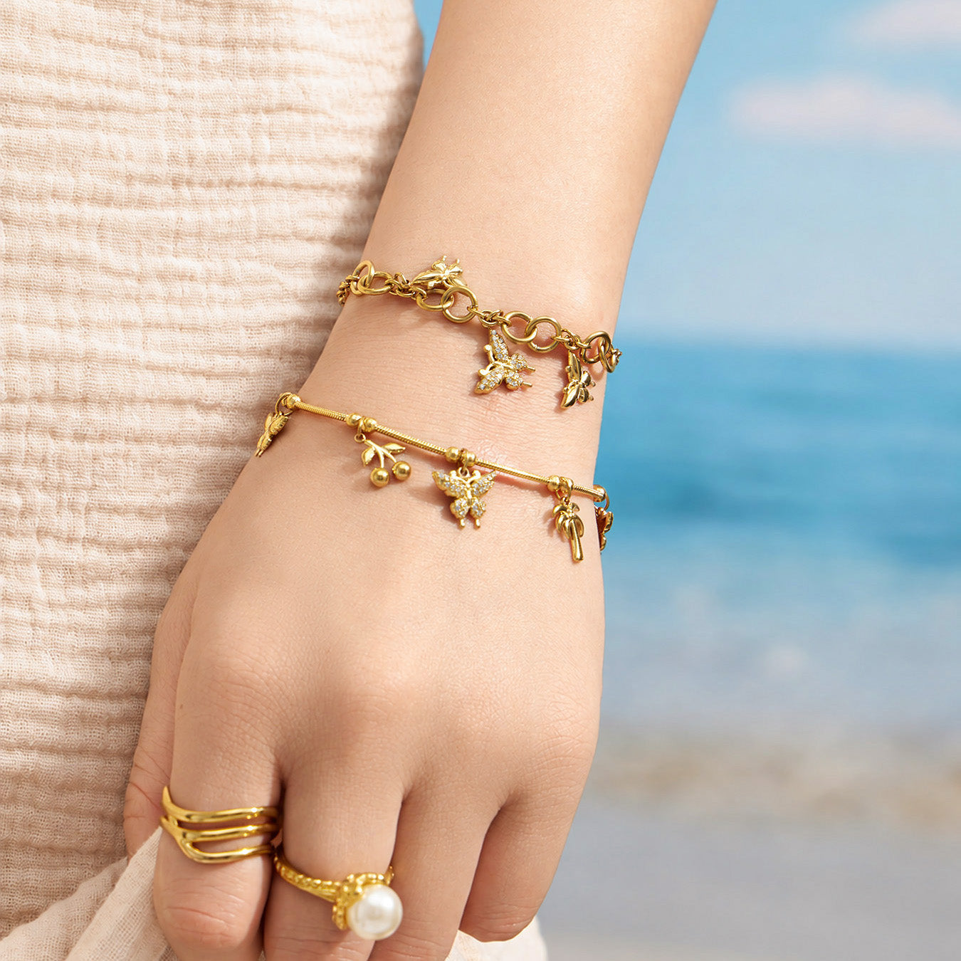 Gold butterfly zircon bracelet worn outdoors on a model wrist