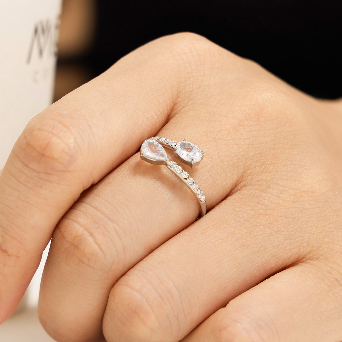 Gold-tone stainless steel adjustable ring with clear glass stone and white cubic zirconia on hand