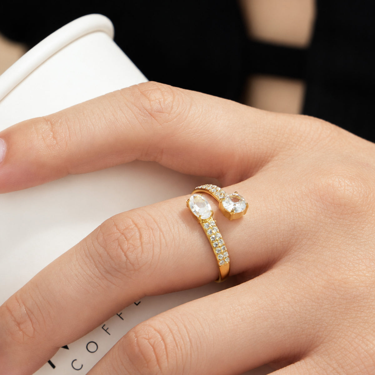 Gold-tone stainless steel cubic zirconia open ring styled on hand for a minimalist jewelry look