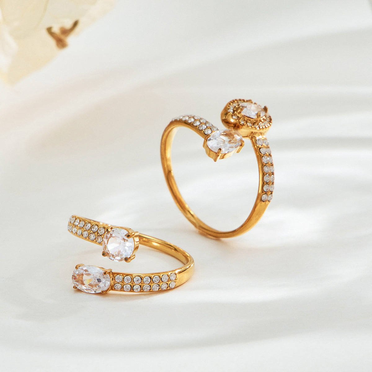 Pair of gold-tone stainless steel adjustable open rings with double cubic zirconia details