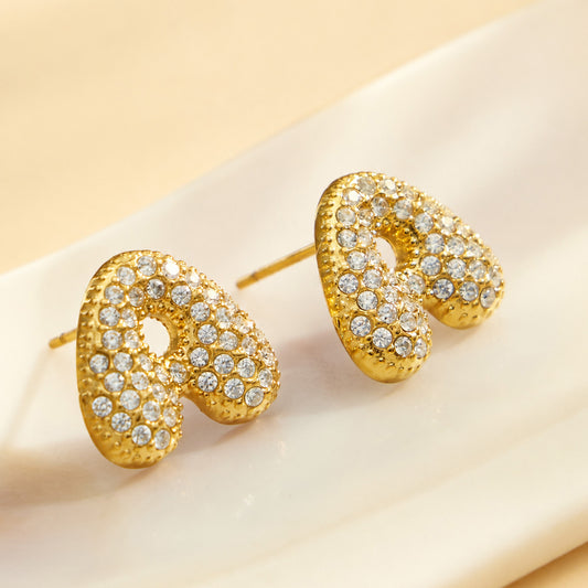 Close-up of pavé gold letter A initial stud earrings