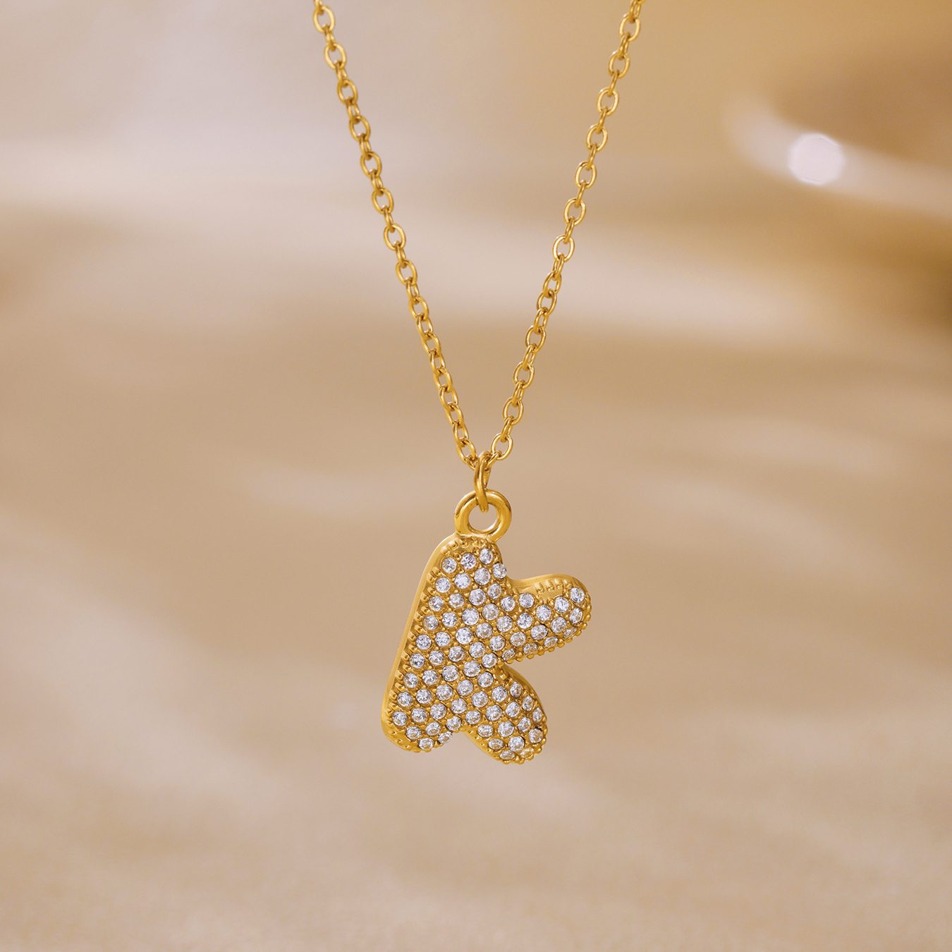 Gold letter K iced out initial necklace with sparkling zircon pendant and gold tone chain