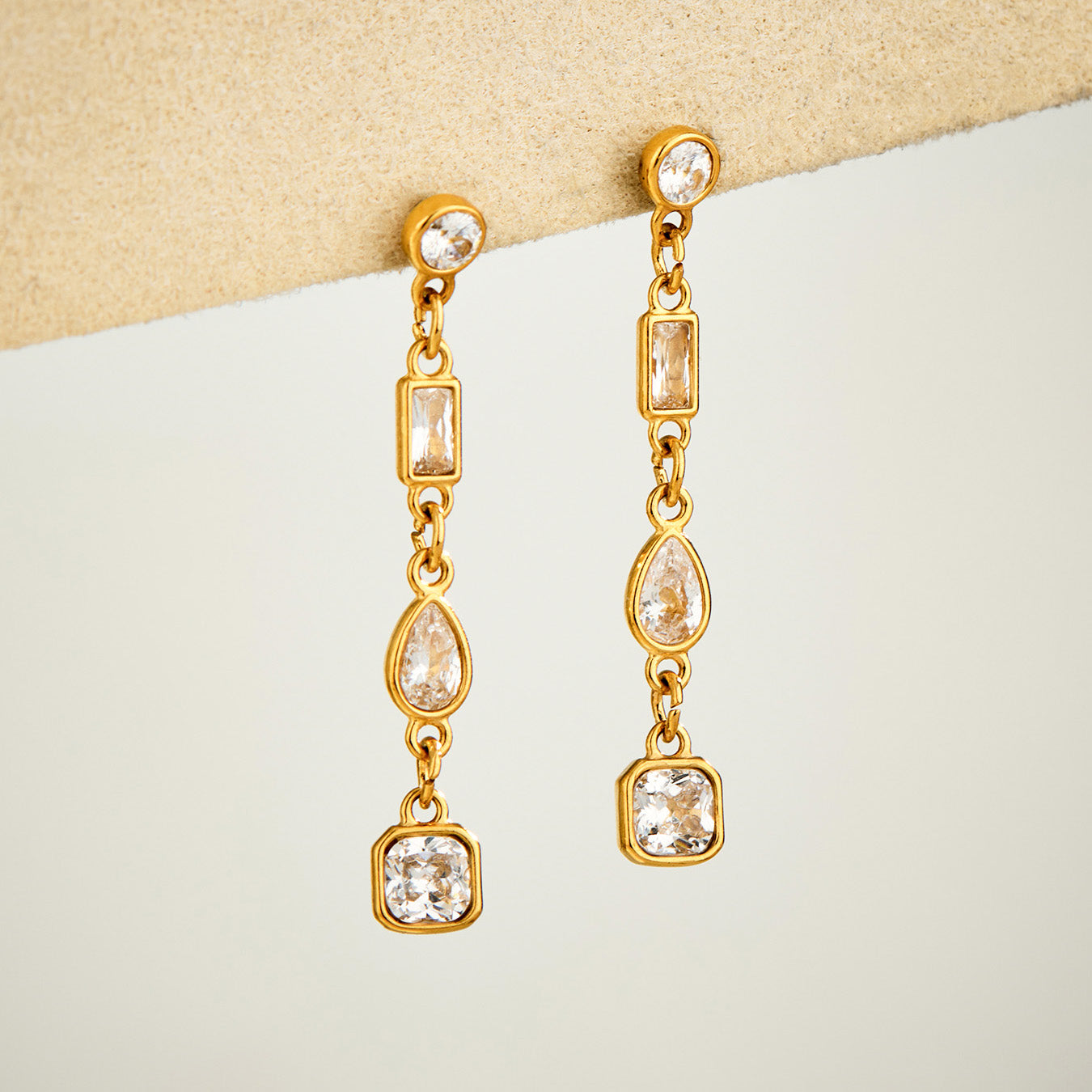 Gold linear cubic zirconia drop earrings with delicate long dangle design