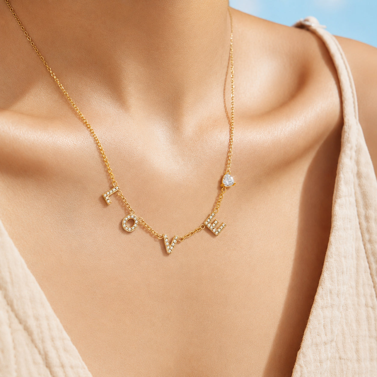 Model wearing a delicate gold LOVE letter zircon pendant necklace