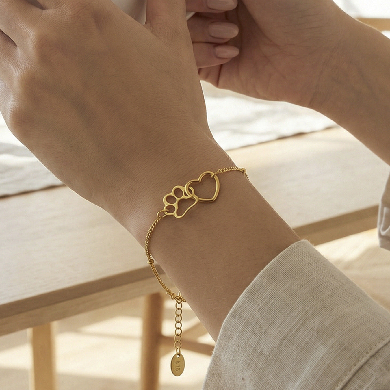 Gold paw print heart bracelet styled in an everyday lifestyle look