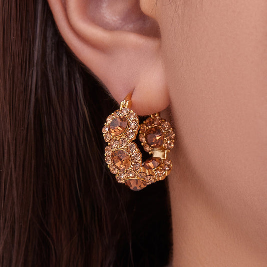 Model wearing gold plated copper pavé zircon U-shaped ear cuff earrings