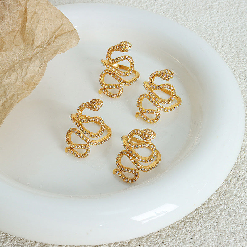 Gold snake cubic zirconia statement ring in a lifestyle jewelry display
