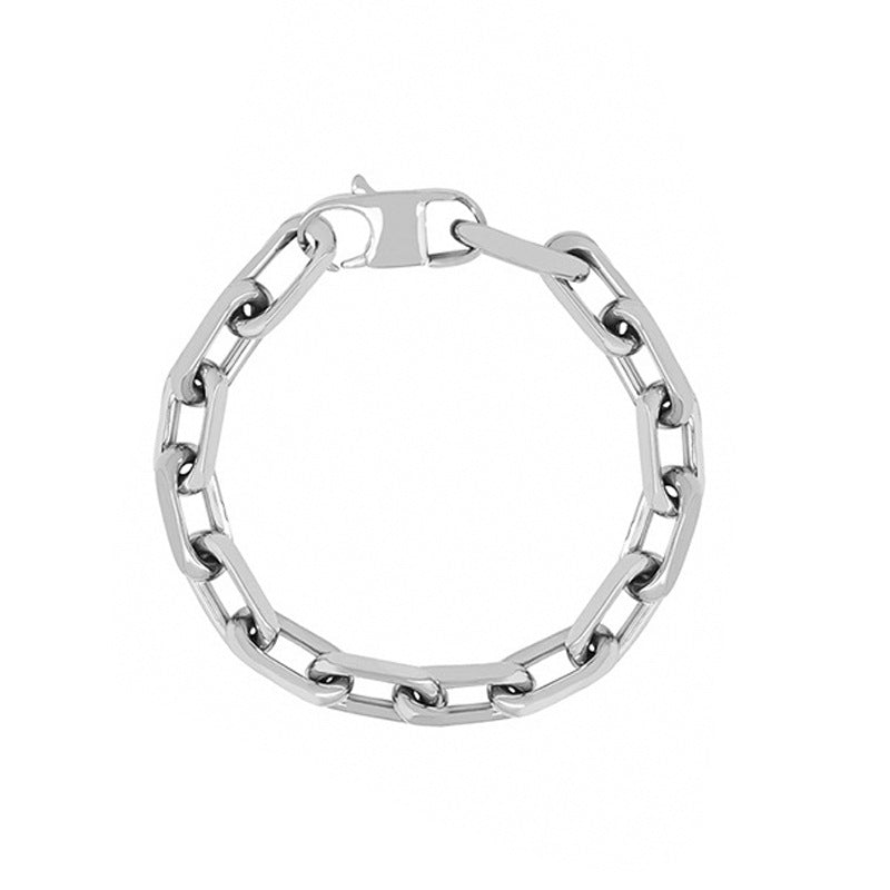 Close-up of a model wearing a gold stainless steel chain bracelet
