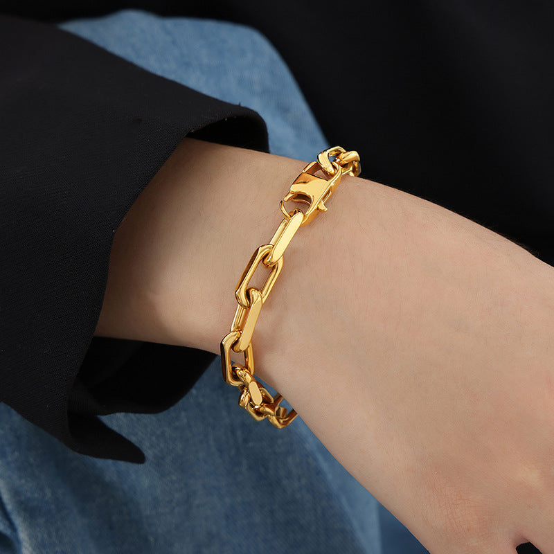 Close-up detail of gold stainless steel chunky chain necklaces showing polished links