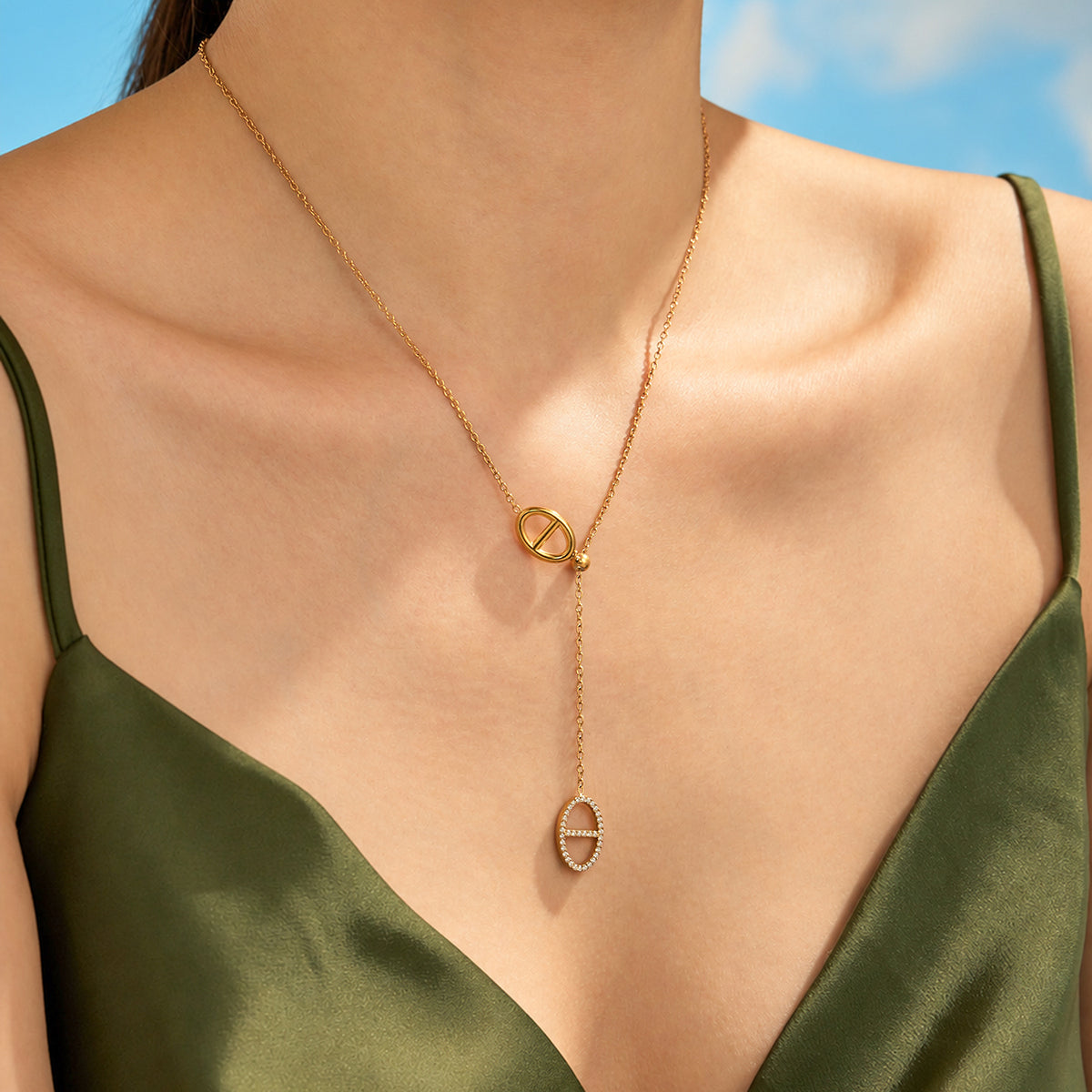 Close-up of a gold plated stainless steel geometric link necklace worn at the neckline