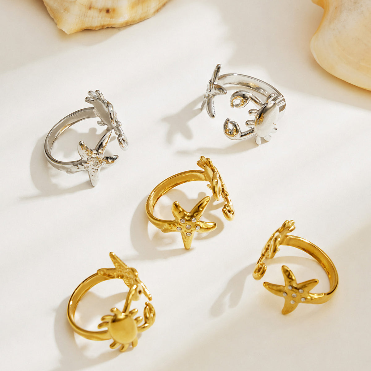 Gold and Steel crab and starfish open rings shown together in 316L stainless steel